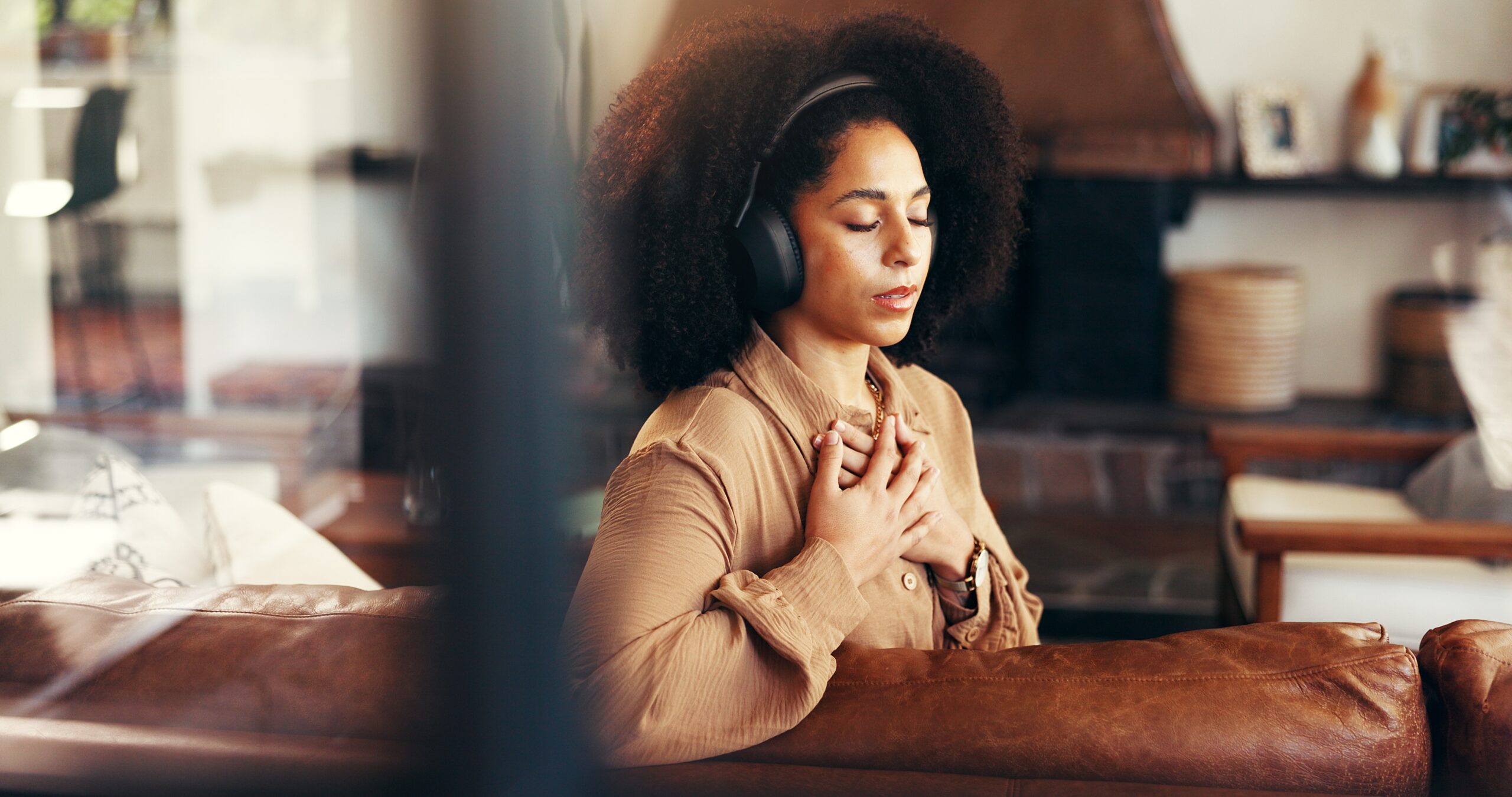 Young woman holding hands and wearing headphones